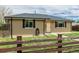 Close-up of the charming home highlighting the brick exterior and the front door at 710 4Th St, Bennett, CO 80102