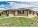 Lovely single-story home with a brick facade and well-maintained landscaping at 710 4Th St, Bennett, CO 80102