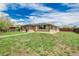 Single-story brick home features a spacious front yard at 710 4Th St, Bennett, CO 80102