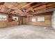Unfinished two car garage showcasing raw ceiling and walls, windows and a large opening door at 710 4Th St, Bennett, CO 80102