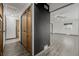 Hallway highlighting wood doors, contrasting black accent wall, and hardwood floors at 710 4Th St, Bennett, CO 80102