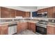 Well-lit kitchen featuring stainless steel appliances, plentiful wooden cabinets, and tile backsplash at 710 4Th St, Bennett, CO 80102