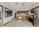 Updated kitchen features stainless steel appliances, plentiful wooden cabinets, and tile backsplash at 710 4Th St, Bennett, CO 80102
