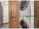 Laundry room with stackable washer and dryer, conveniently located near the hallway at 710 4Th St, Bennett, CO 80102