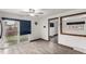 Bright living room featuring sliding glass doors to backyard, ceiling fan, and wood-look floors at 710 4Th St, Bennett, CO 80102