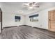 Spacious living room boasts wood-look floors and ample natural light from two windows at 710 4Th St, Bennett, CO 80102