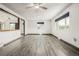 Bright, open living room with ceiling fan and stylish wood-look flooring at 710 4Th St, Bennett, CO 80102