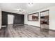 Open living room with wood-look flooring, a ceiling fan, and a pass-through view to the kitchen at 710 4Th St, Bennett, CO 80102