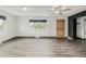 Spacious living room featuring a ceiling fan, wood-look floors, and natural light at 710 4Th St, Bennett, CO 80102