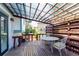 Covered back deck with wooden furniture, providing a relaxing outdoor living space at 772 Ivywood Ct, Highlands Ranch, CO 80126