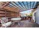 Outdoor wooden deck with pergola, stylish seating, and a charming dog house, perfect for entertaining at 772 Ivywood Ct, Highlands Ranch, CO 80126