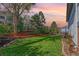 Well-maintained backyard featuring lush green grass, mature trees, and a beautiful landscaped area at 772 Ivywood Ct, Highlands Ranch, CO 80126