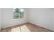 Light-filled bedroom with hardwood floors and a large window offering outdoor views at 772 Ivywood Ct, Highlands Ranch, CO 80126