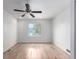 Bright bedroom with light hardwood floors, a ceiling fan and a window offering natural light at 772 Ivywood Ct, Highlands Ranch, CO 80126