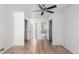 Spacious bedroom with hardwood floors and multiple doorways leading to a bathroom and closets at 772 Ivywood Ct, Highlands Ranch, CO 80126