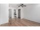 Sunlit bedroom with hardwood floors, access to a bathroom and a closet with custom shelving at 772 Ivywood Ct, Highlands Ranch, CO 80126