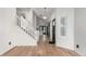 Inviting foyer with hardwood floors, a white staircase, and plenty of natural light from the front door at 772 Ivywood Ct, Highlands Ranch, CO 80126