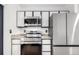 This kitchen features modern appliances, sleek countertops, and stylish cabinetry at 772 Ivywood Ct, Highlands Ranch, CO 80126