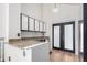 Bright kitchenette features sleek white cabinets, granite countertops, and access to a door with glass panels at 772 Ivywood Ct, Highlands Ranch, CO 80126