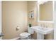 Bathroom with a pedestal sink, toilet, and framed art at 6374 Arapahoe Ct, Parker, CO 80134