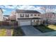 Aerial view of a charming home with a two-car garage and landscaped surroundings at 13684 Lilac St, Thornton, CO 80602