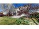 Private backyard with stone patio and mature trees creates an inviting outdoor oasis at 13684 Lilac St, Thornton, CO 80602