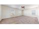 Spacious bedroom featuring three windows for natural light, carpet, and ceiling fan at 13684 Lilac St, Thornton, CO 80602