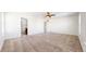 Spacious bedroom featuring three windows for natural light, carpet, and access to bathroom at 13684 Lilac St, Thornton, CO 80602