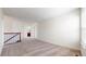 Spacious, carpeted room with bright lighting and a staircase to another level at 13684 Lilac St, Thornton, CO 80602