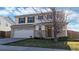 Two-story home featuring a brick and siding exterior, attached two-car garage, and a well-manicured front lawn at 13684 Lilac St, Thornton, CO 80602