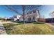 Suburban two-story home with well-maintained lawn and mature trees on a sunny day at 13684 Lilac St, Thornton, CO 80602