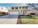 Charming two-story home featuring a two-car garage and landscaped front yard at 13684 Lilac St, Thornton, CO 80602