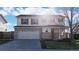 Two-story home featuring a two-car garage and landscaped front yard at 13684 Lilac St, Thornton, CO 80602
