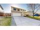 Two-story home with a large driveway and well-maintained lawn at 13684 Lilac St, Thornton, CO 80602