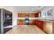 Bright kitchen features wood cabinets, stainless steel appliances, and a modern refrigerator at 13684 Lilac St, Thornton, CO 80602