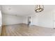 Expansive living area with wood floors, modern lighting, and plenty of space for relaxation and entertaining at 13684 Lilac St, Thornton, CO 80602