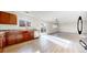 Open concept living room featuring stainless steel appliances, hardwood floors and bright lighting at 13684 Lilac St, Thornton, CO 80602