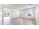 Bright living room with light wood flooring and natural light from multiple windows at 13684 Lilac St, Thornton, CO 80602