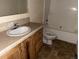 Bathroom with a single sink vanity, toilet, and tub with shower at 5500 Dacono Ct, Byers, CO 80103