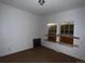 Bright bedroom with boarded windows offers renovation potential at 5500 Dacono Ct, Byers, CO 80103