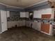 Incomplete kitchen shows tile backsplash, missing appliances and damaged flooring at 5500 Dacono Ct, Byers, CO 80103