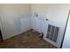 Small laundry room features wall damage and tile floor at 5500 Dacono Ct, Byers, CO 80103