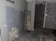 Bare room with grey painted drywall and unfinished areas. Ready to be customized at 5500 Dacono Ct, Byers, CO 80103