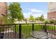 Relaxing balcony space with black metal railing overlooking a well-maintained green lawn and trees at 3401 Arapahoe Ave # 105, Boulder, CO 80303