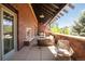 Spacious balcony lounge area with comfortable seating, brick accents, and a covered structure for relaxation at 3401 Arapahoe Ave # 105, Boulder, CO 80303