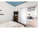 Bedroom with a blue accent ceiling and sliding doors to the main living area at 3401 Arapahoe Ave # 105, Boulder, CO 80303