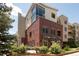 Beautiful exterior of a brick building with modern design elements, complemented by well-maintained greenery at 3401 Arapahoe Ave # 105, Boulder, CO 80303