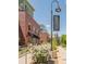 Charming exterior of a brick apartment complex featuring black awnings, signage, and manicured landscaping at 3401 Arapahoe Ave # 105, Boulder, CO 80303