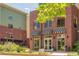Striking exterior showcasing modern architecture with brick facade and awnings, complemented by lush landscaping at 3401 Arapahoe Ave # 105, Boulder, CO 80303