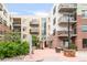 A well-maintained courtyard entrance provides a welcoming space with seating and landscaping at the property at 3401 Arapahoe Ave # 105, Boulder, CO 80303